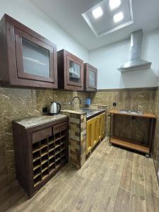 a kitchen with wooden cabinets and a counter top at NO PROBLEM in Yerevan