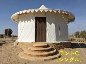 a small tent with stairs leading to a door at Sonal Desert Camp Jaisalmer in Kūri