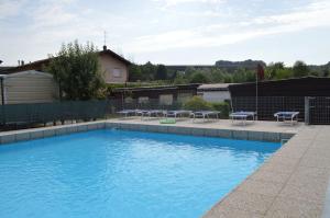 a swimming pool with blue water in a yard at Campeggio Piano Grande in Baveno