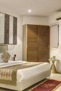 a bedroom with a large bed and a large window at Hotel Transit International- Aerocity Delhi Airport in New Delhi