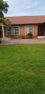 a house with a green lawn in front of it at Molata Rabs in Polokwane