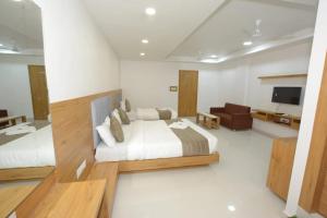 sypialnia z dużym łóżkiem i telewizorem w obiekcie HOTEL GREEEN LEAF w mieście Anand