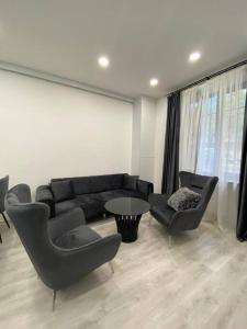 a living room with a couch and chairs and a table at Apartment in Yerevan in Yerevan