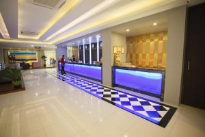 a lobby with a checkered floor in a building at Grand Pink Hotel Hatyai in Hat Yai