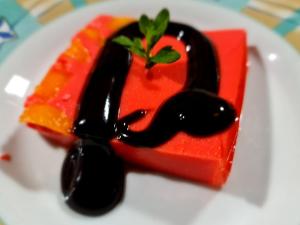 a piece of dessert with black sauce on a white plate at Reserva y Estancia Robles Mimosos Lodge in Cartago
