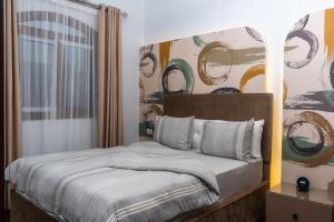 a bedroom with a bed with a painting on the wall at Premium apartment in new cairo in Cairo