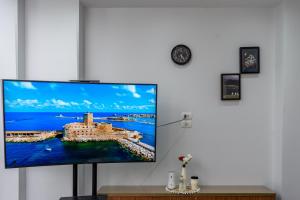 a flat screen tv hanging on a white wall at Premium apartment in new cairo in Cairo