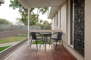 a patio with two chairs and a table on a porch at Your unit at Southside Central in Bundaberg