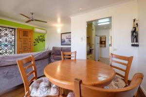 a living room with a table and a couch at Your unit at Southside Central in Bundaberg