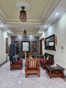 a living room with couches and tables in a room at Sari Ayuning Nusa Guest House in Nusa Lembongan +22 photos