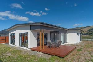 a small house with a deck and a table at The Shepherds Retreat in Richmond