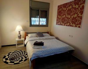 um pequeno quarto com uma cama e uma janela em Open-space apartment by the SEA em Asdode