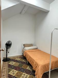 a small bedroom with a bed and a floor at Amir Homestay in Yong Peng