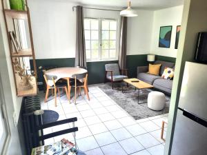 Magnolia Cottage في ميزون لافيت: غرفة معيشة مع أريكة وطاولة