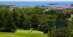 a view of a park with people playing golf at Hotel & Spa Gil de France Cap d'Agde in Cap d'Agde