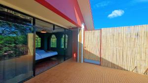 a hallway of a house with a view of a bedroom at 80 Bar Hostel in Coron