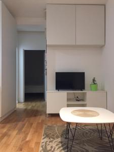 a living room with a table and a tv at Velesajam in Zagreb