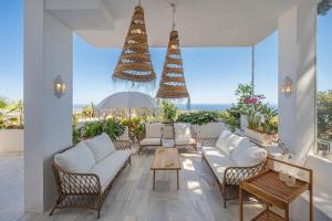 een woonkamer met witte meubels en uitzicht op de oceaan bij Selecta - Dream Apartment in Marbella in La Mairena