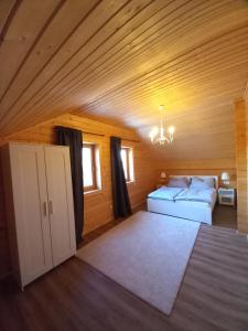 a bedroom with a bed in a wooden room at Gemütliches Holzhaus in Gamlitz in Gamlitz