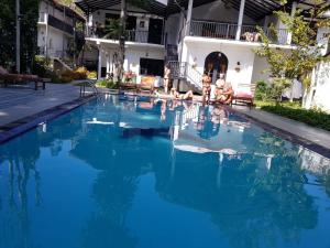 a group of people sitting in a swimming pool at Ella Forest Paradise Hotel in Ella