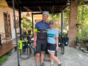 a man and a woman standing next to a bike at ครูหนูบ้านพัก แหลมงอบ Krunou baanpak in Trat