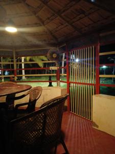 a restaurant with a table and chairs and a fence at Lake Homes in Varkala