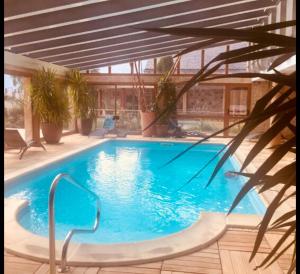 a large blue swimming pool in a house at Petit cocon des montagnes in Bolquere Pyrenees 2000