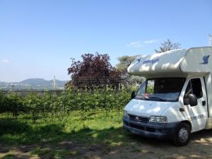 a white food truck parked in a field at ROCCOLO in Morbio Inferiore