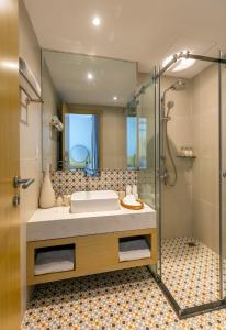 a bathroom with a sink and a shower at Sanayen Villa & Residences in Da Nang