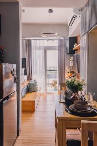 a kitchen and living room with a table and a couch at Saint Honore Studio Retreat with Amenities in Iloilo City