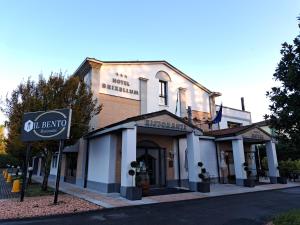 a building with a sign in front of it at Hotel Brixellum in Brescello