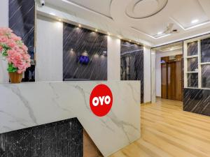 a lobby with a vox logo on the wall at OYO Hotel bhanu Villa in Ahmedabad