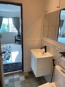 a bathroom with a sink and a mirror at English owned Homestay and Yoga in Chalong 