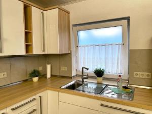 a kitchen with a sink and a window at Ferienwohnung Wanderlust in Bachem