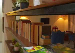 a shelf filled with books on a wall at Elite Room - A Home Away in Jaipur