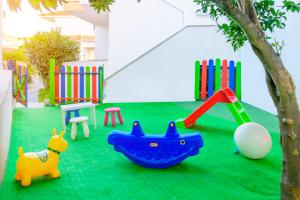 a playground with a toy dog and a swing at Maria Rooms in Polychrono