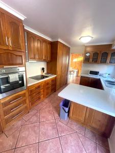 a kitchen with wooden cabinets and a white counter top at Relaxation Holiday Home in Bellerive in Bellerive