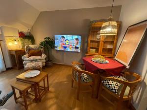 uma sala de estar com uma mesa e uma televisão em Apartamento con terraza (Morriña) em Sada