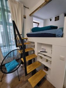 a bedroom with a bunk bed and a spiral staircase at Casa Silvia in Cluj-Napoca