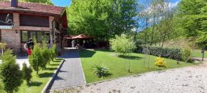 a garden in front of a house at Villa FORESTA in Banja Luka