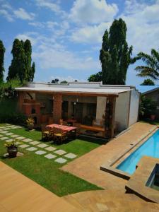 a house with a garden and a swimming pool at Sprunger Avenue - tulia homes in Moshi