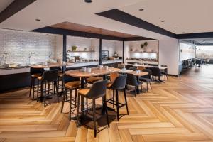 a restaurant with wooden tables and chairs and a bar at Delta Hotels by Marriott Quebec in Quebec City