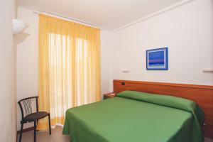 A bed or beds in a room at Residence Il Monello