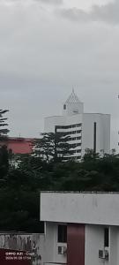 ein hohes weißes Gebäude mit einem Turm darüber in der Unterkunft hotel seri liny in Kuching