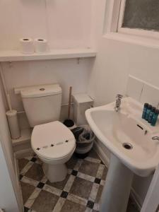 a bathroom with a toilet and a sink at Tudors eSuites Budget Studio Apartment in Birmingham