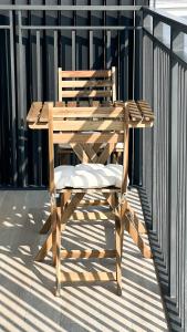 a wooden chair sitting on top of a balcony at Canal view 3 bedroom holiday home with balcony in Abu Dhabi