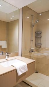 a bathroom with a sink and a shower and a mirror at Canal view 3 bedroom holiday home with balcony in Abu Dhabi