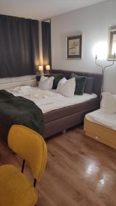 a hotel room with a bed and two chairs at Stressless Sun aktivCARD Bayerischer Wald inklusive in Sankt Englmar +43 photos