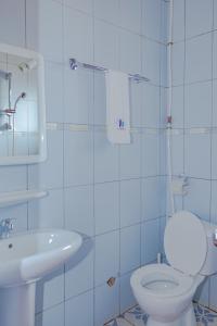 COMPLEXE GROUPE NJAYOU SARL-U (CGN HOTEL) في Mapara: حمام به مرحاض أبيض ومغسلة