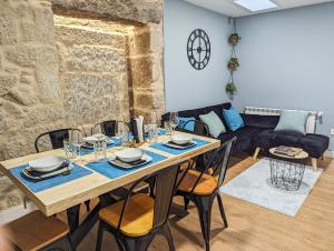 a dining room with a table and chairs and a couch at Pedra Nova - Céntrico, Lujoso in Pontevedra +18 photos